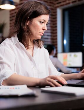 Businesswoman sitting in office workspace and working on computer