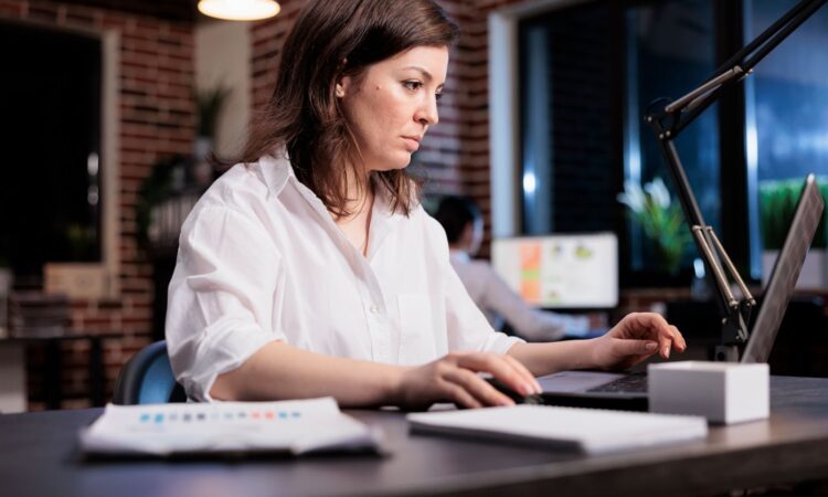 Businesswoman sitting in office workspace and working on computer