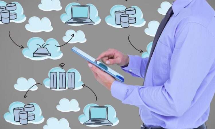 A man using a tablet with cloud computing icons floating around him