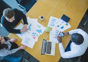 Business people discussing something at the table, top view