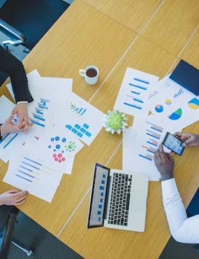 Business people discussing something at the table, top view