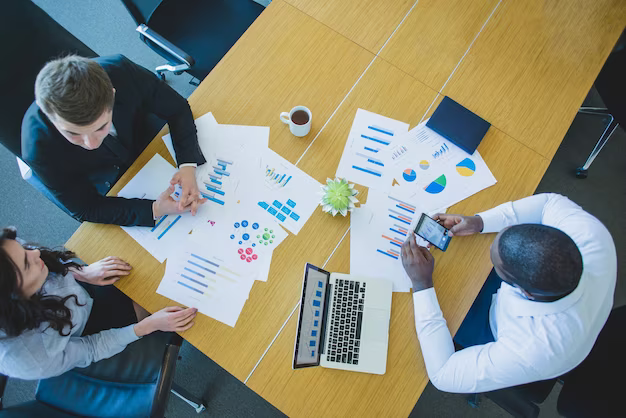 Business people discussing something at the table, top view