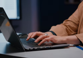 A man typing on a computer keyboard