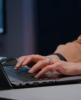 A man typing on a computer keyboard