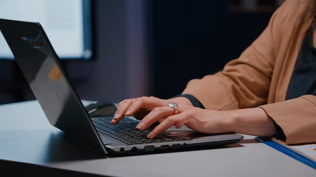 A man typing on a computer keyboard